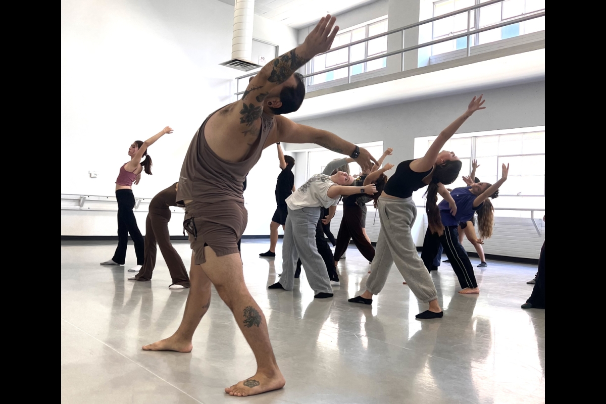 Dancers in a room mid-movement.