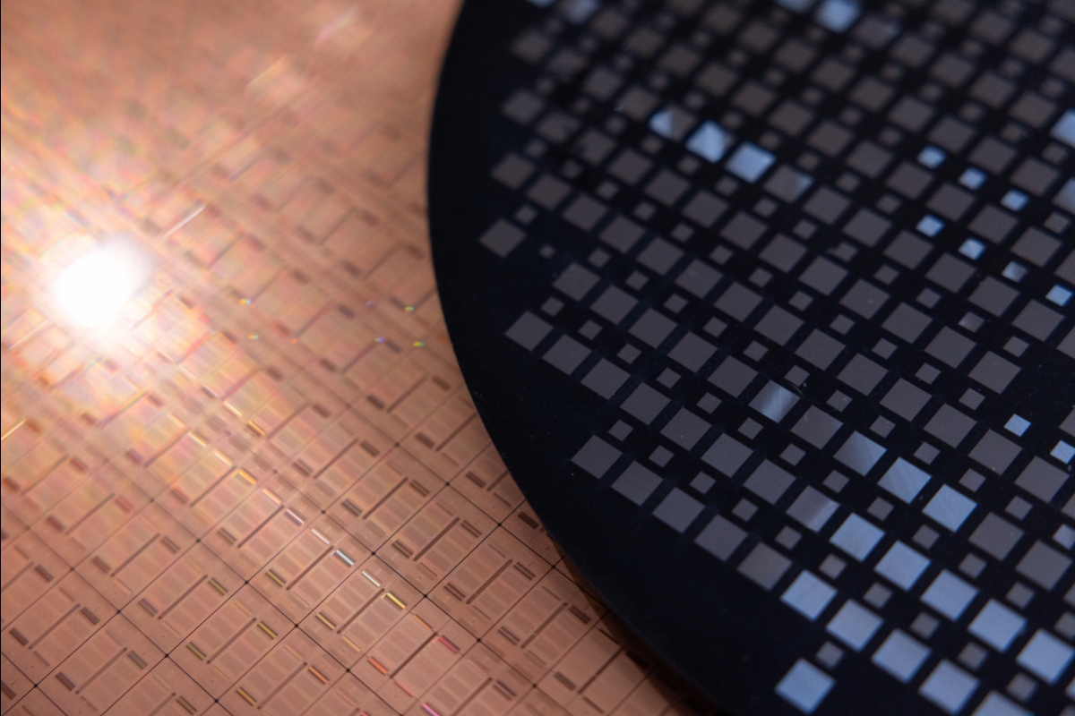 A closeup of a silicon wafer next to a molded wafer