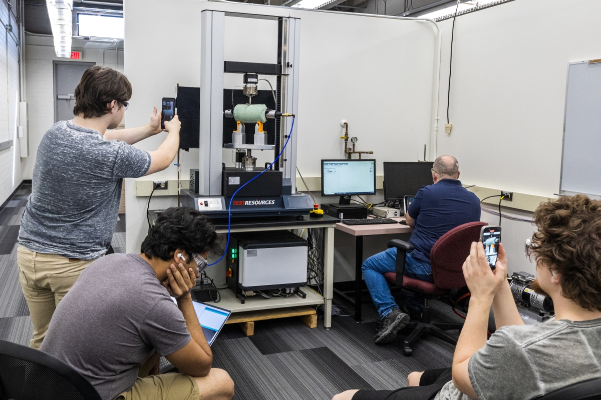 Students record video of pressure being applied to object in lab