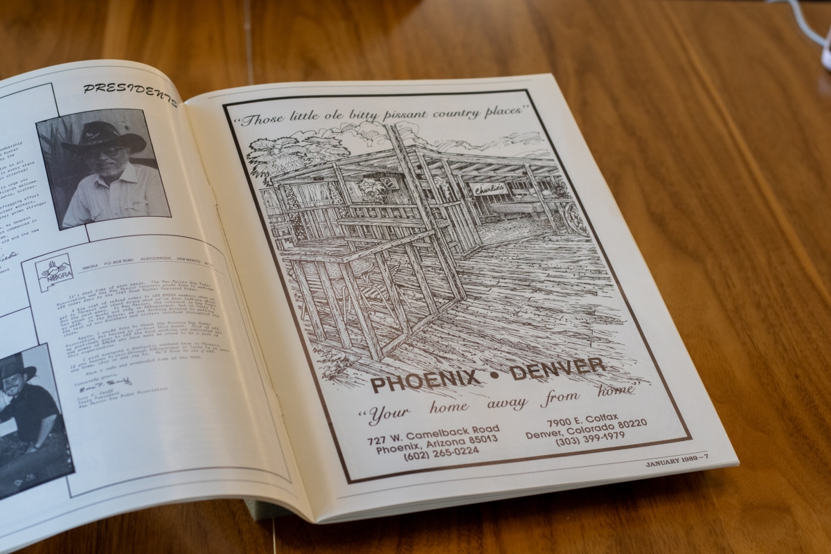 Opened black and white magazine with sketch of a building labeled 