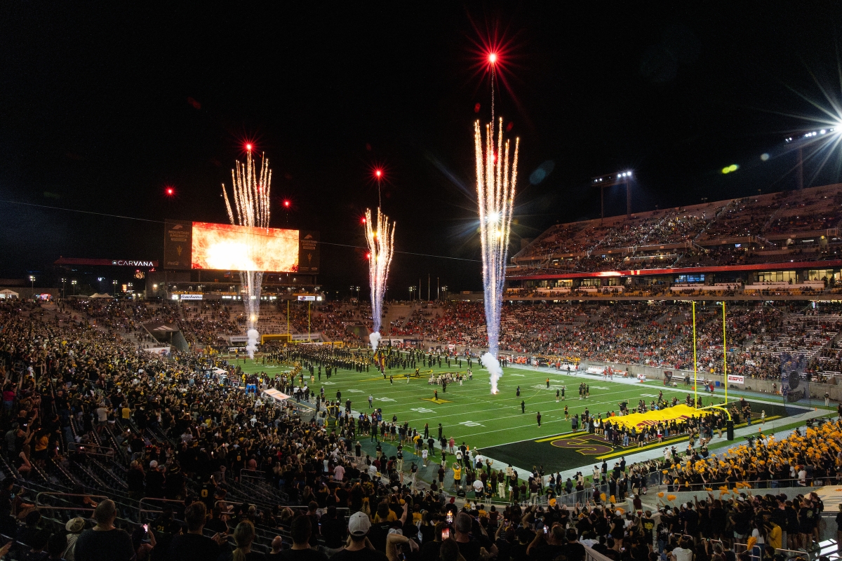 Fireworks shoot off over football stadium filled with fans