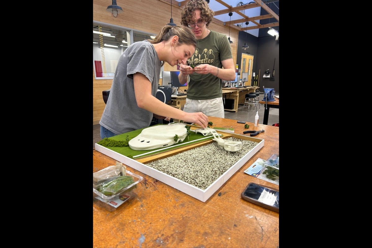 young woman and young man with a building model