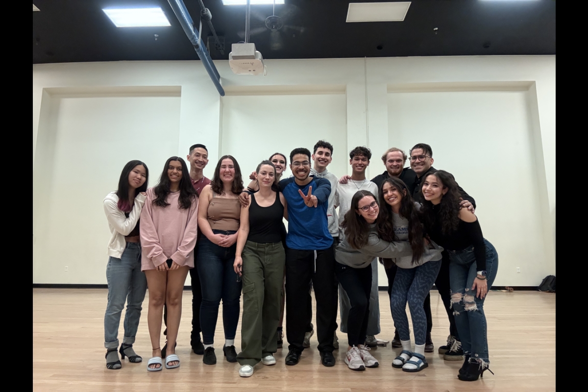 Group of people smiling for the camera in a dance studio.