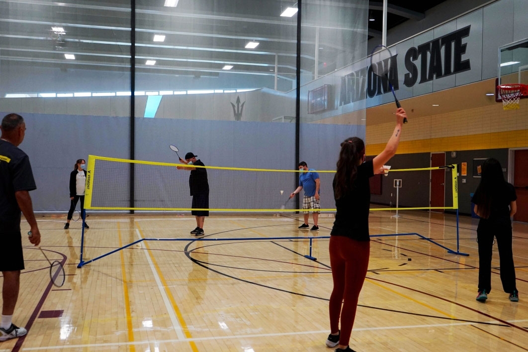 people playing badminton on indoor court