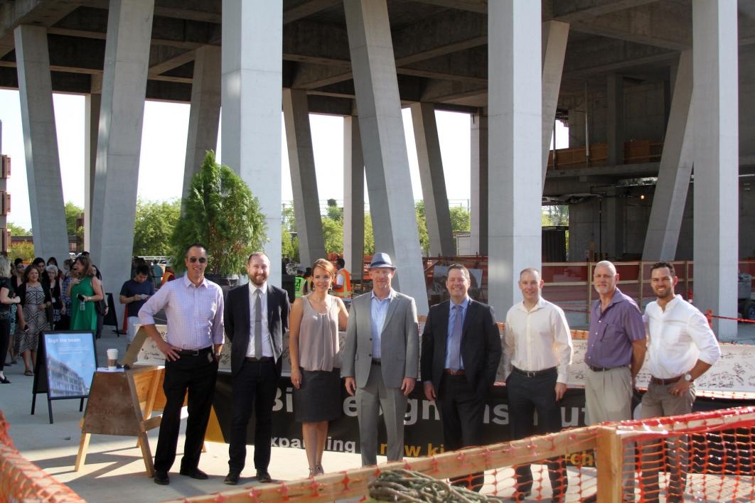 People pose for a photo at the Biodesign C topping-out ceremony