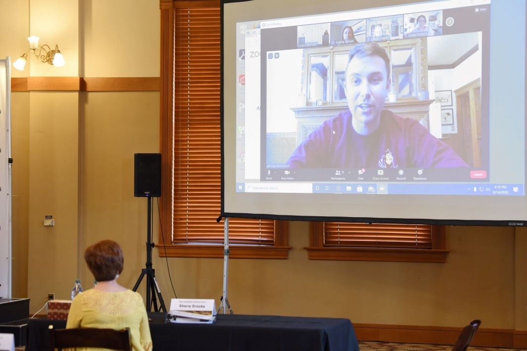 person speaking on screen via Zoom to people at ASU's Tempe campus