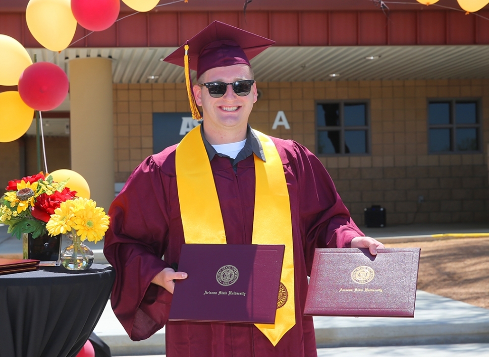 ASU@Lake Havasu City's, TJ Cook proudly displays two of his earned diplomas