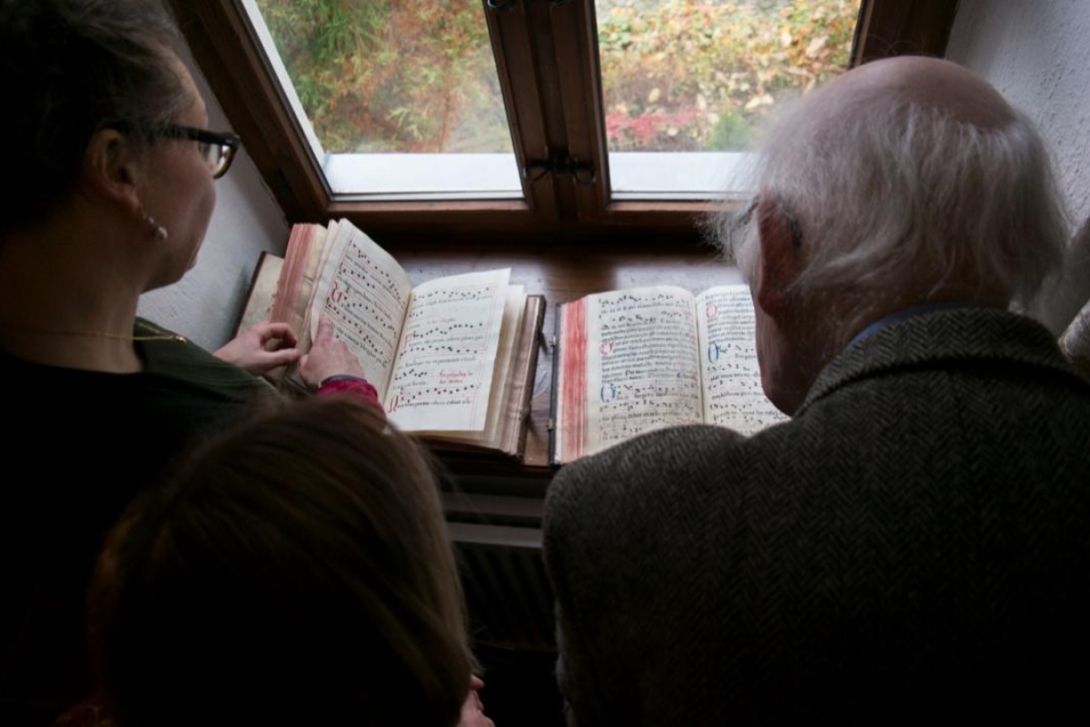people reading books on a window sill