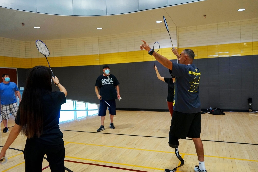people playing badminton on indoor court