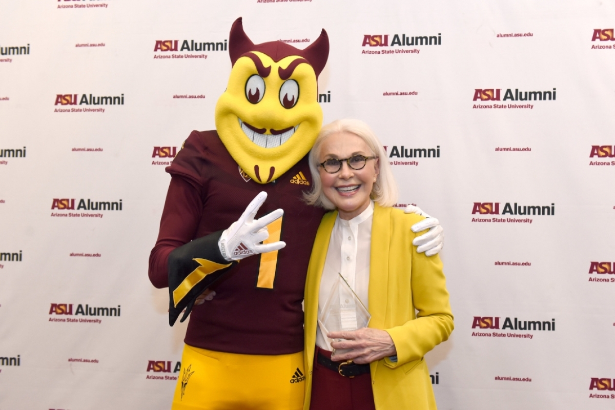 Woman posing with ASU mascot Sparky the Sun Devil.