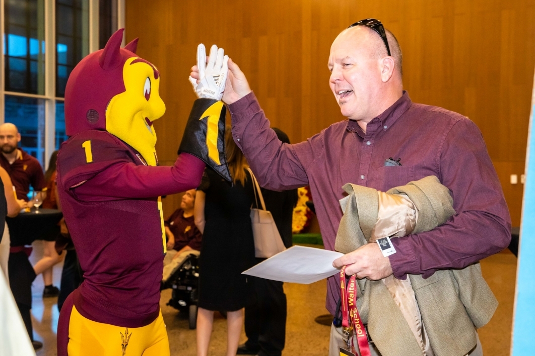 2023 Affinity Reunion goer and Sparky high-five.