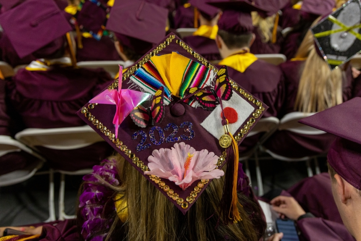 A close-up photo of a graduation cap decorated colorfully.