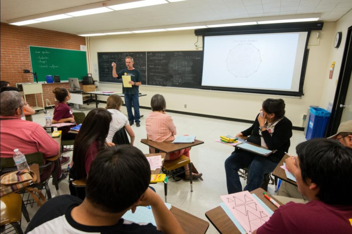 man speaking to classroom full of students