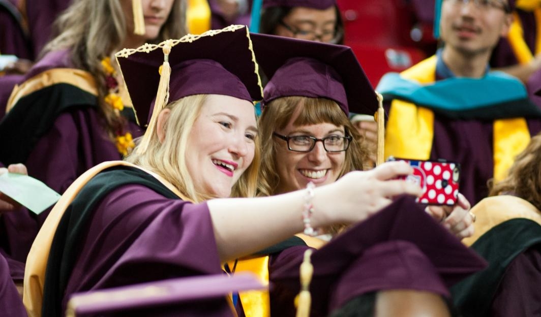 Students take selfies at ASU's Graduate Commencement