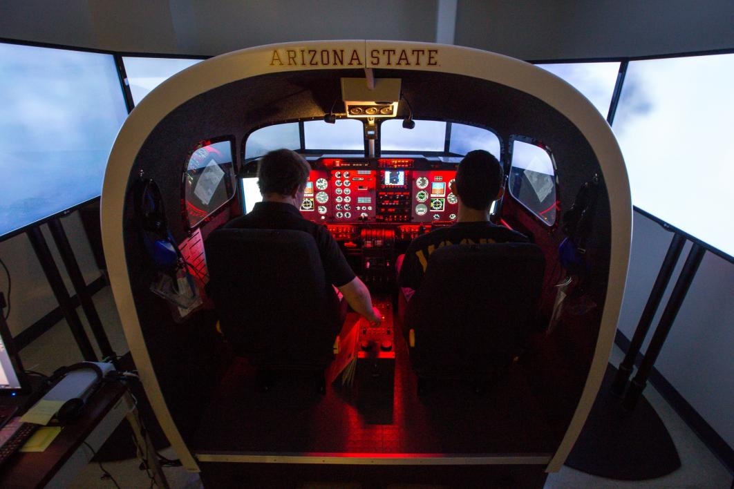 Aviation students in a flight simulator.