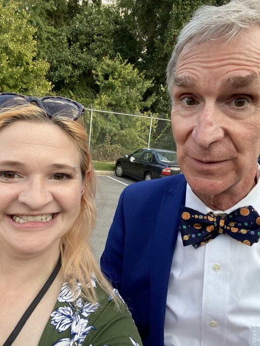 Selfie of a woman and a man wearing a suit and bow tie.