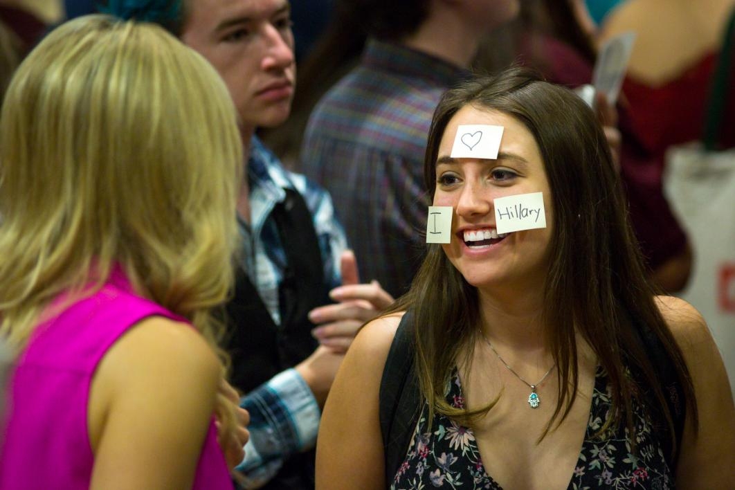 A young woman poses with post-its on her face at the Chelsea Clinton talk