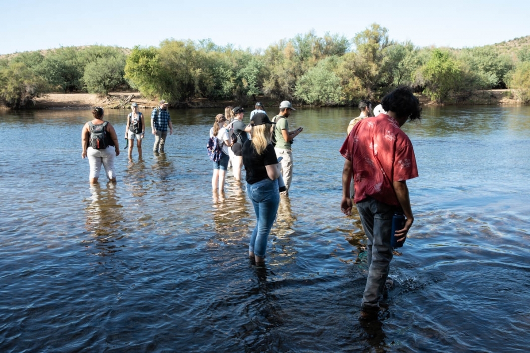 Students wading in river