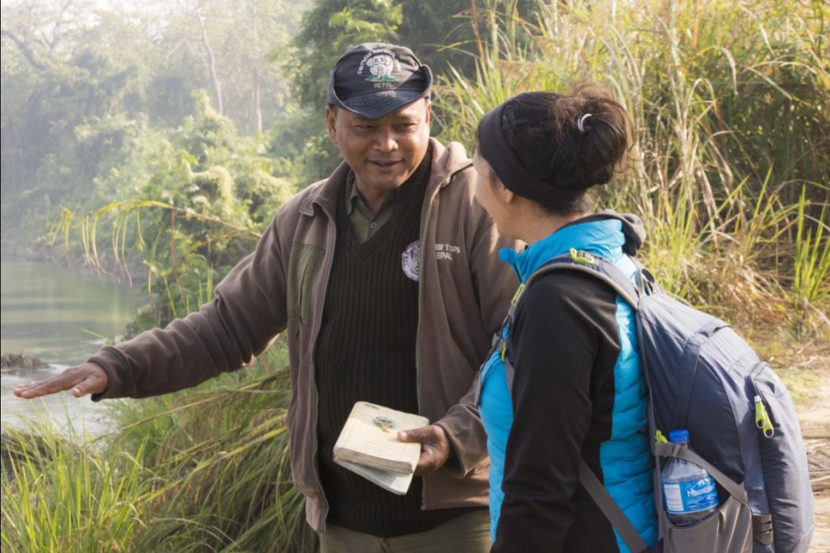 Michele Clark speaking with a guide at Chitwan National Park