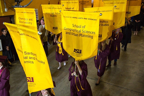 grads carrying banners into convocation