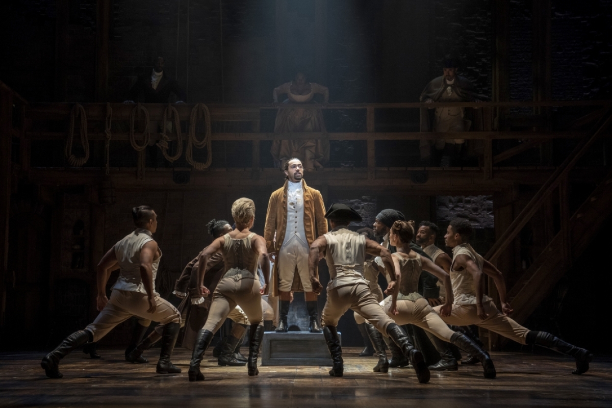 Performers on stage of "Hamilton."