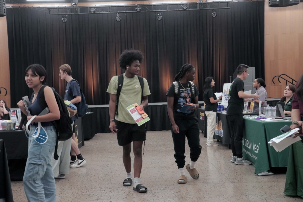 students walking around a tabling/networking event