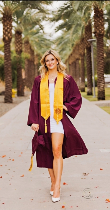 woman wearing cap and gown on ASU's Palm Walk