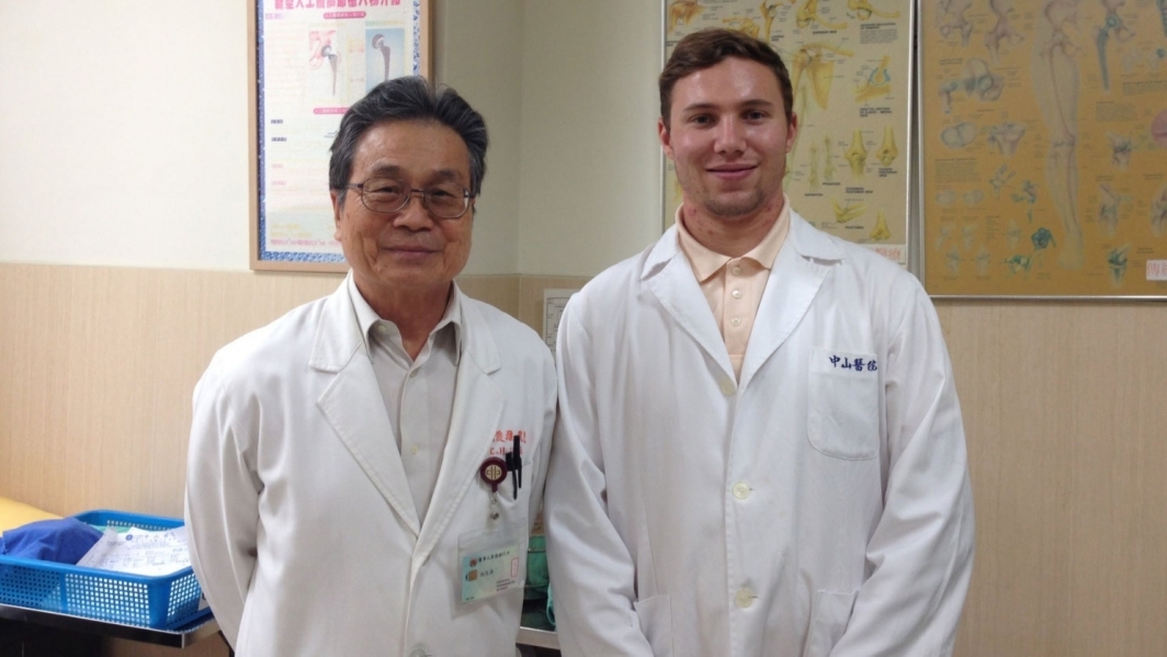 Grand Challenges Scholar Dean Spyres (right) poses with an orthopedic surgeon at Taipei Chang Gung Memorial Hospital.