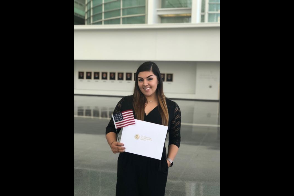 Hernandez holds her citizenship certificate and American flag