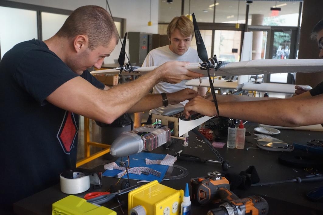 Luke Burgett (left) and Max Stauffer work on the aircraft at the Air Devils student organization workspace at Arizona State University