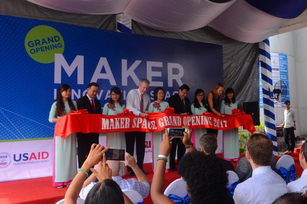 Photo of nine people behind a red ribbon that say Maker Space Grand Opening 2017.