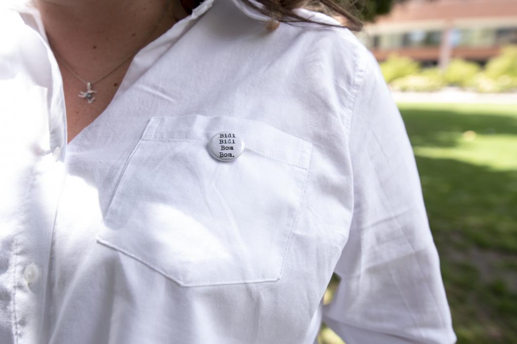 Monica De La Torre, an associate professor in The College's School of Transborder Studies, dons a pin with the name of one of Selena's most famous songs, "Bidi Bidi Bom Bom."