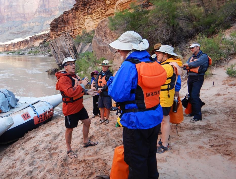School of Earth and Space Exploration professor Ramon Arrowsmith describes the geological sites ahead to a group of passengers taking part in the Institute of Human Origins' Colorado River trip last May.
