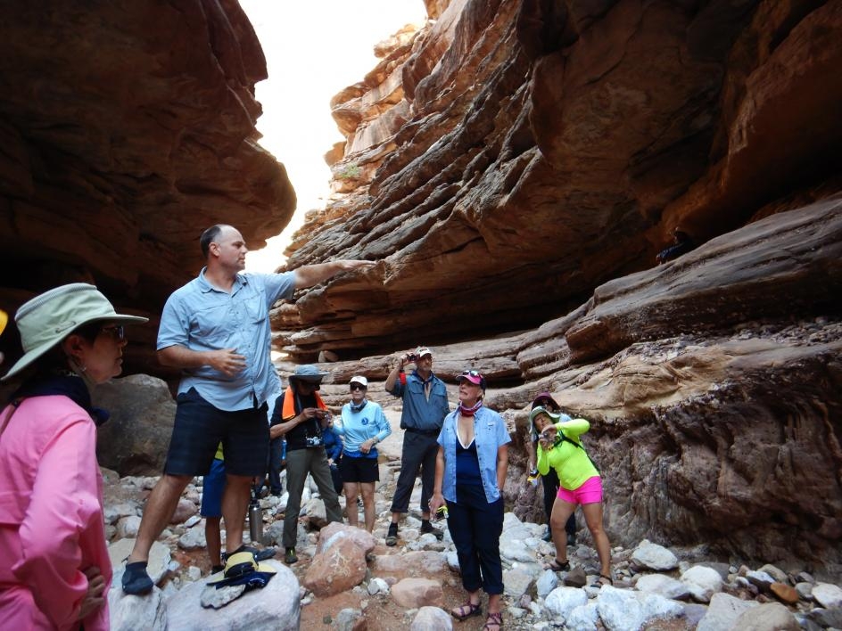 Chris Campisano, an associate professor in The College's School of Human Evolution and Social Change, points out a geological formation on the canyon wall called the Great Unconformity to passengers on the trip. 