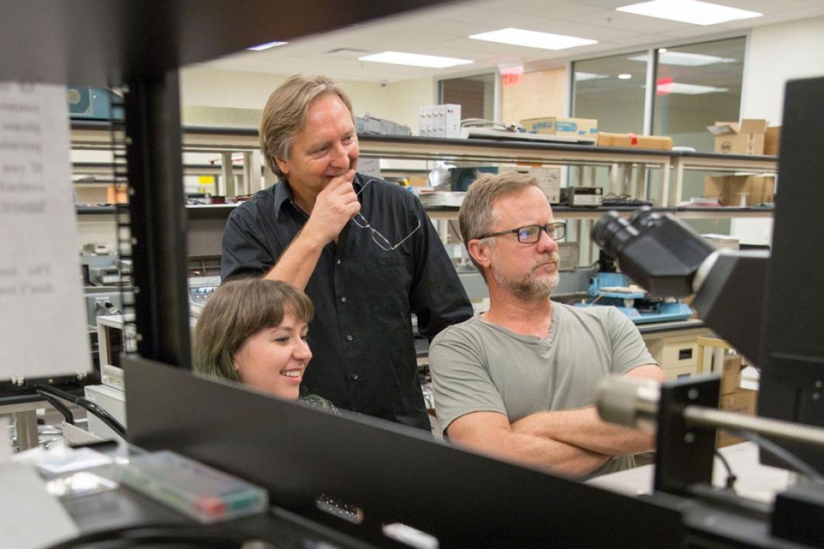 Associate Professor Hugh Barnaby (right) and Professor Michael Kozicki (center) apply their expertise in radiation effects and memory to test next-generation neuromorphic computing architectures for use in critical applications where radiation is a likely