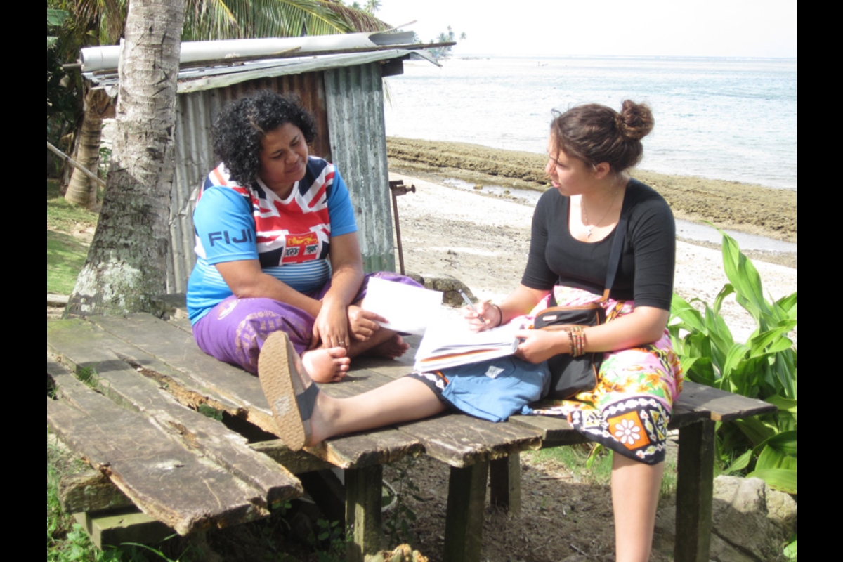 An ASU student interviews a woman in Fiji as part of a research project.
