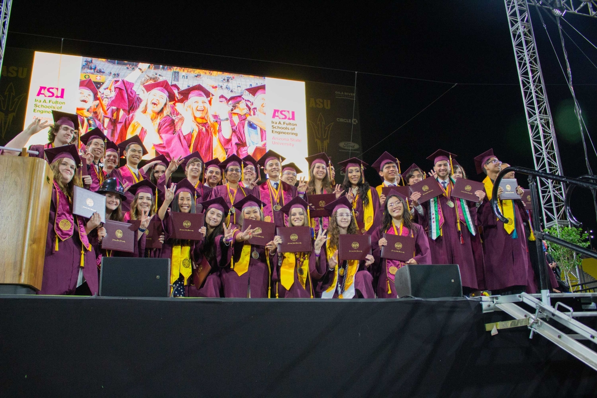 Engineering students celebrating on stage at graduation