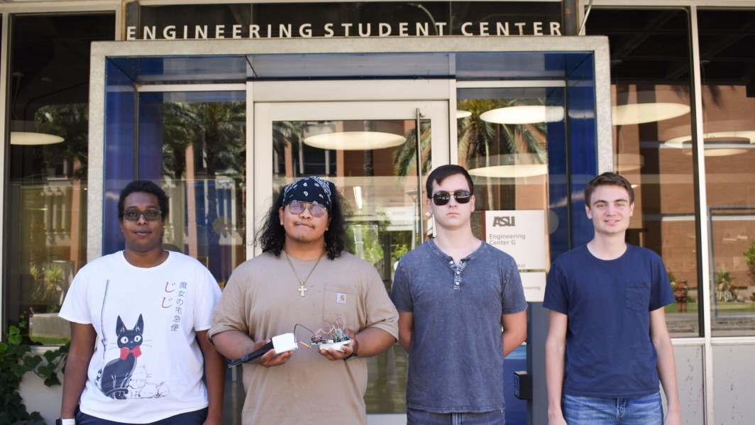 EPICS Vietnam Smart Agriculture student team holding their prototype in front of ASU's Engineering Student Center.