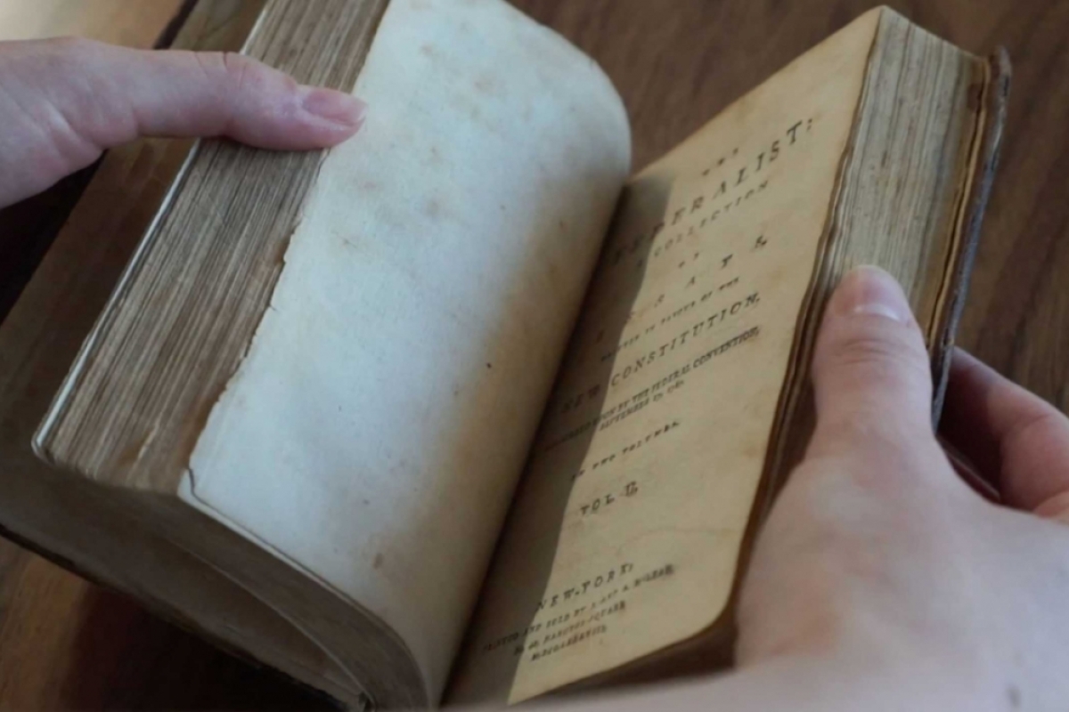 screenshot of video featuring the Federalist essays book