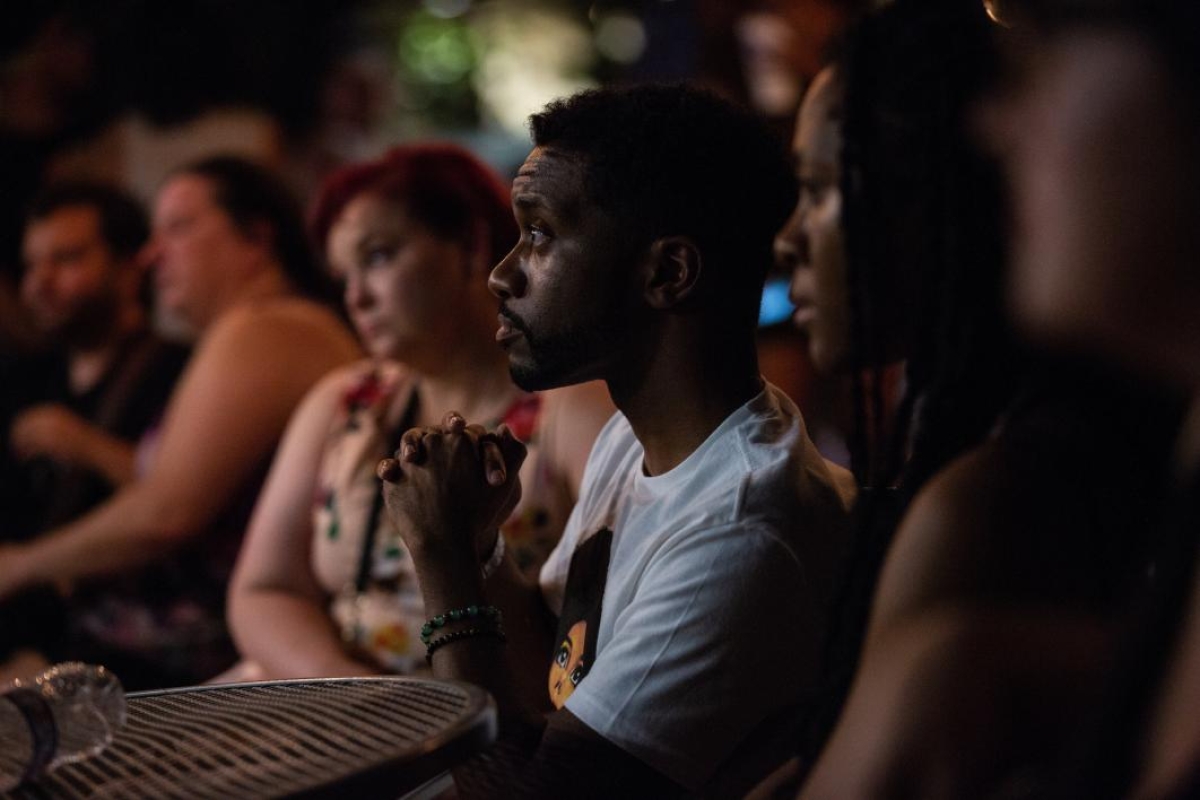 people in an audience listening intently