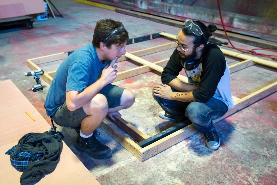 Crewmembers consult on set building.