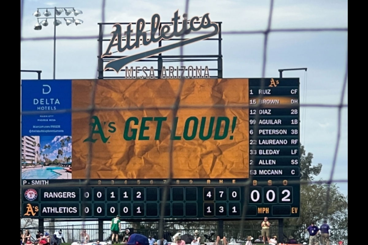 A scoreboard on a baseball field that reads "A's GET LOUD!"