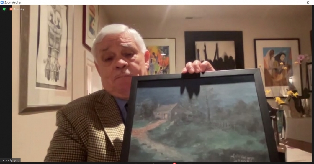 Screenshot of a man holding up a painting to a webcam.