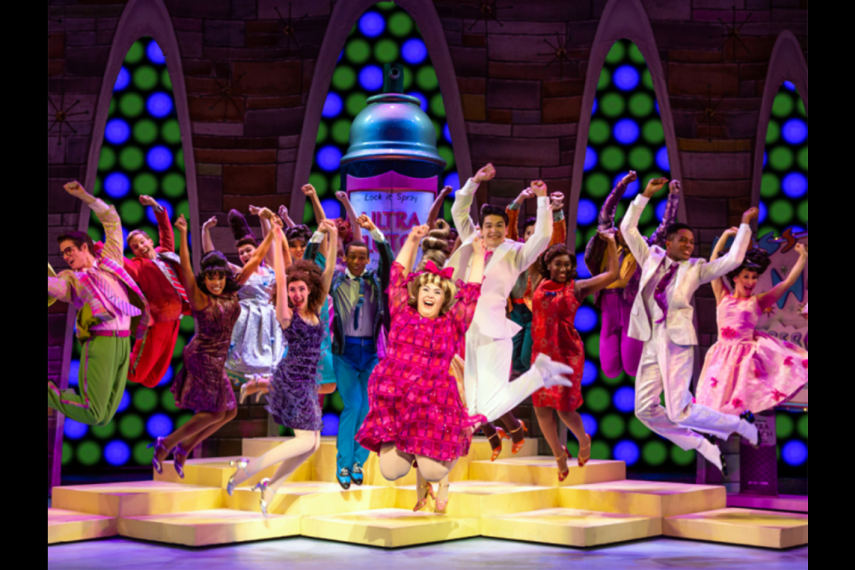 People jumping on stage for production of "Hairspray"