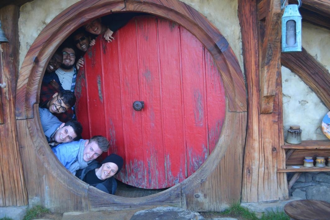students pose in Hobbiton in New Zealand