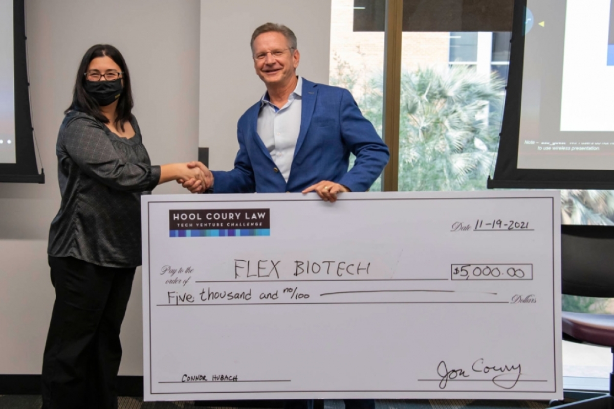Michael Hool presents a $5,000 check to Jennifer Blain Christen at the ASU Hool Coury Law Tech Venture Showcase.