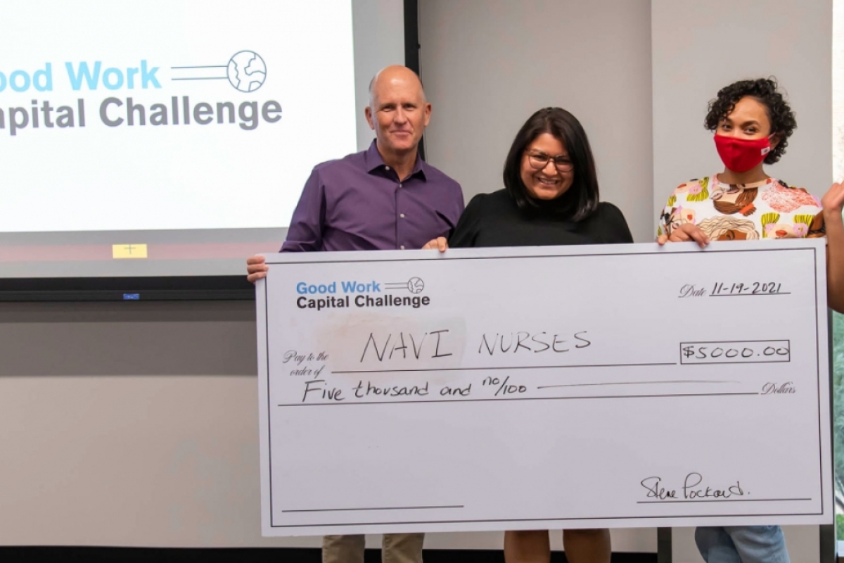 Steve Lockhard presents a $5,000 check to Jasmine Bhatti and her business partner Ayan Said from the Good Work Capital Challenge.