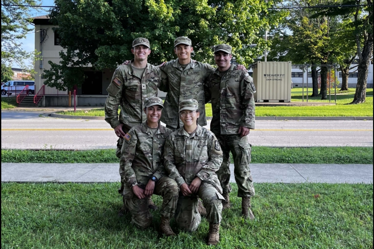 ASU Army ROTC Cadet Hayden Shedd and four other cadets in Army fatigues smiling for a group photo.