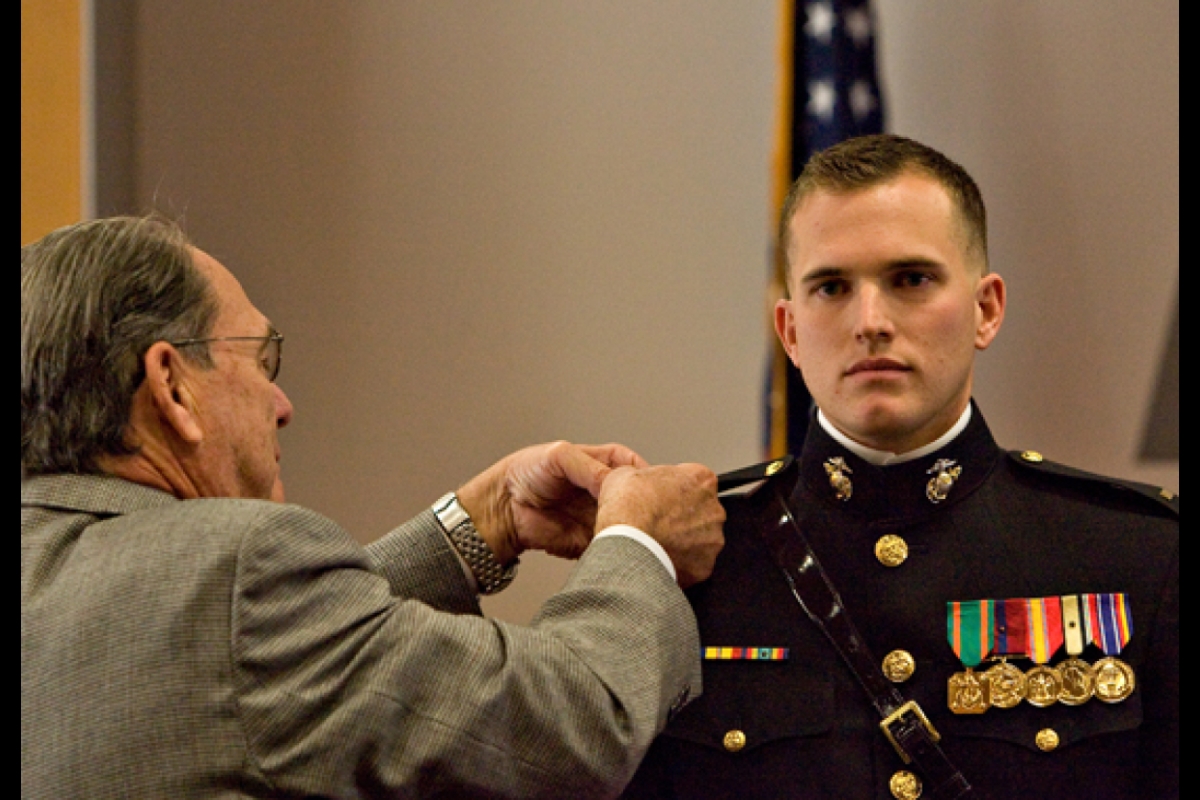 father pinning lieutenant bars on son