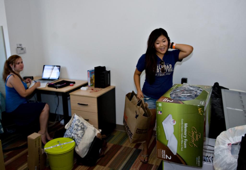 students unpacking in dorm